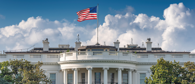 The White House in Washington, D.C., with the U.S. flag flying above the building, symbolising the U.S. government, fiscal policy, and political influence on global markets.