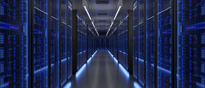 Interior of a modern data center with long rows of server racks on both sides of a central aisle, illuminated by blue LED lights and overhead lighting, conveying large-scale cloud computing and AI infrastructure.