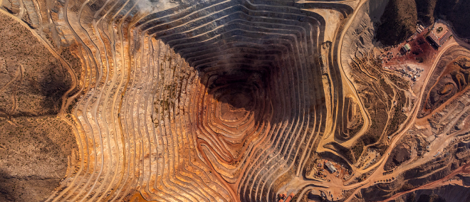 Aerial view of an open-pit mine, illustrating resource extraction and commodities.